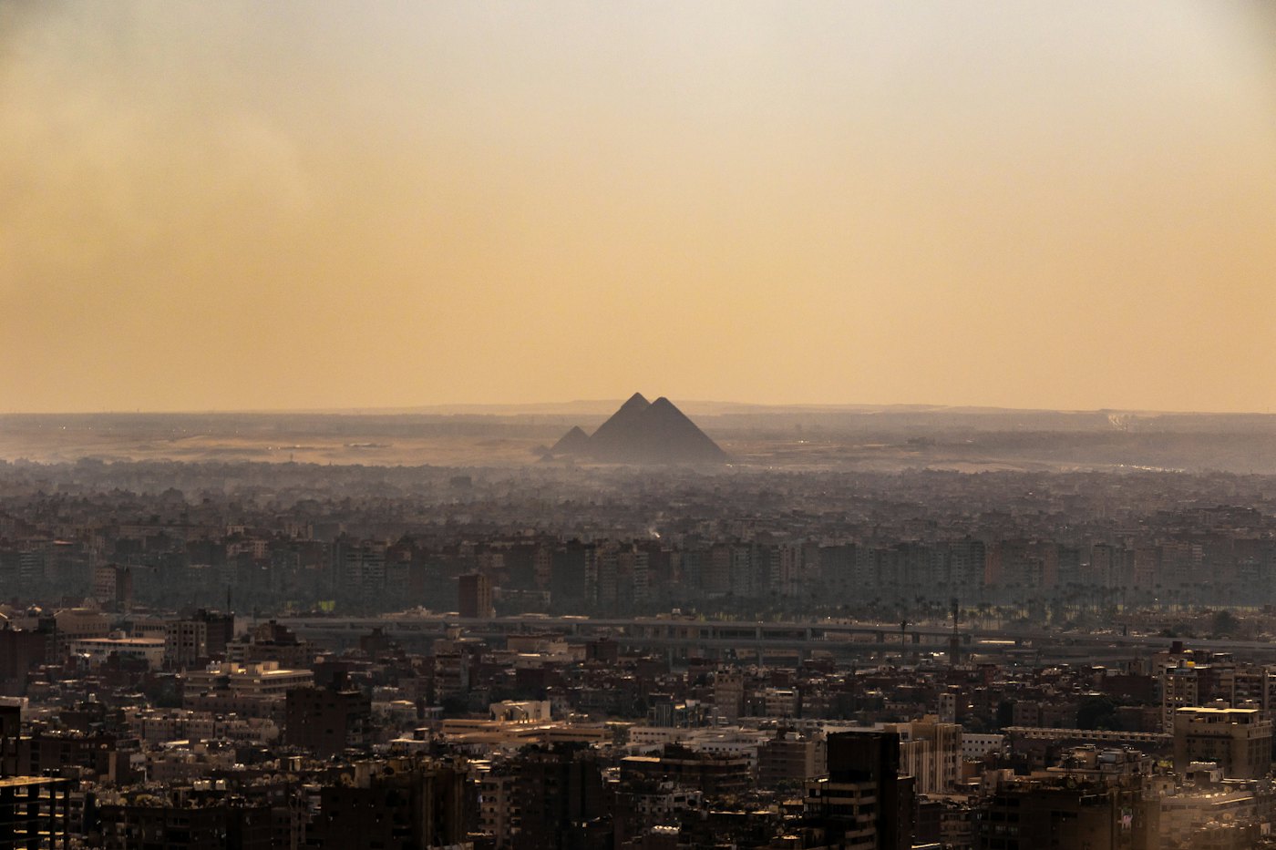 Cairo skyline with pyramids in the distance